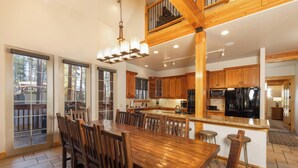 A spacious kitchen with wooden cabinets, a large island, and modern appliances. - Sawmill Run Lodge: Pet-Friendly, Walk to Peak 8, Hot Tub, Grill, Shuttle (Breckenridge)