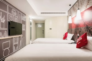 A hotel room with two beds, a TV, and a marble wall.