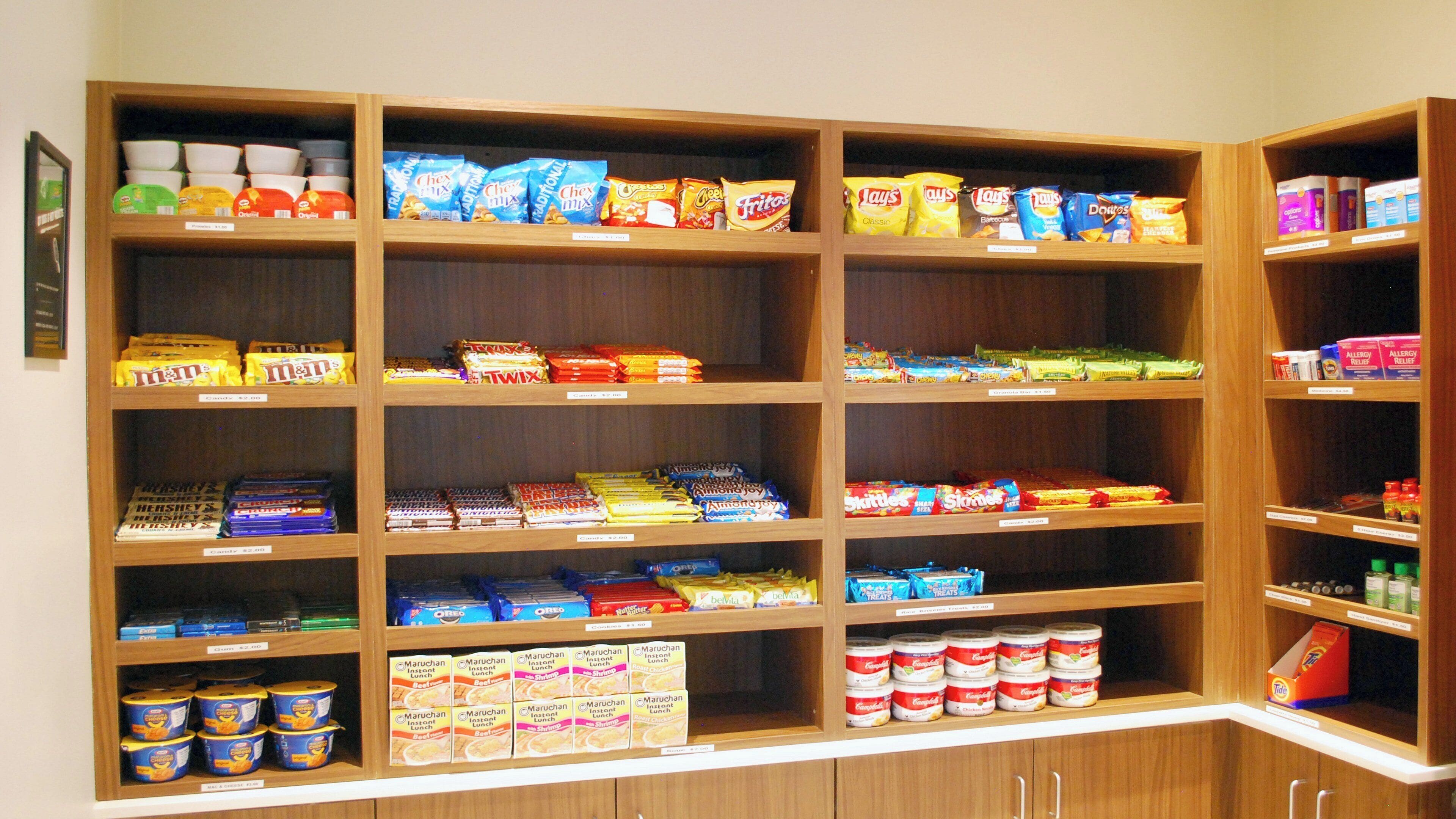 A snack and food display with various brands and types of snacks, including chips and candy.