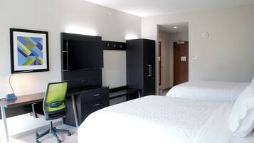 A hotel room with a bed, a desk with a chair, a television, and a wardrobe.