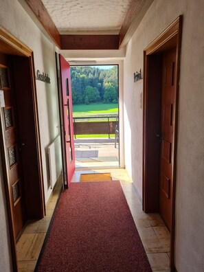 A hallway with a red carpet leading to a door labeled 'Gastrofuse.'