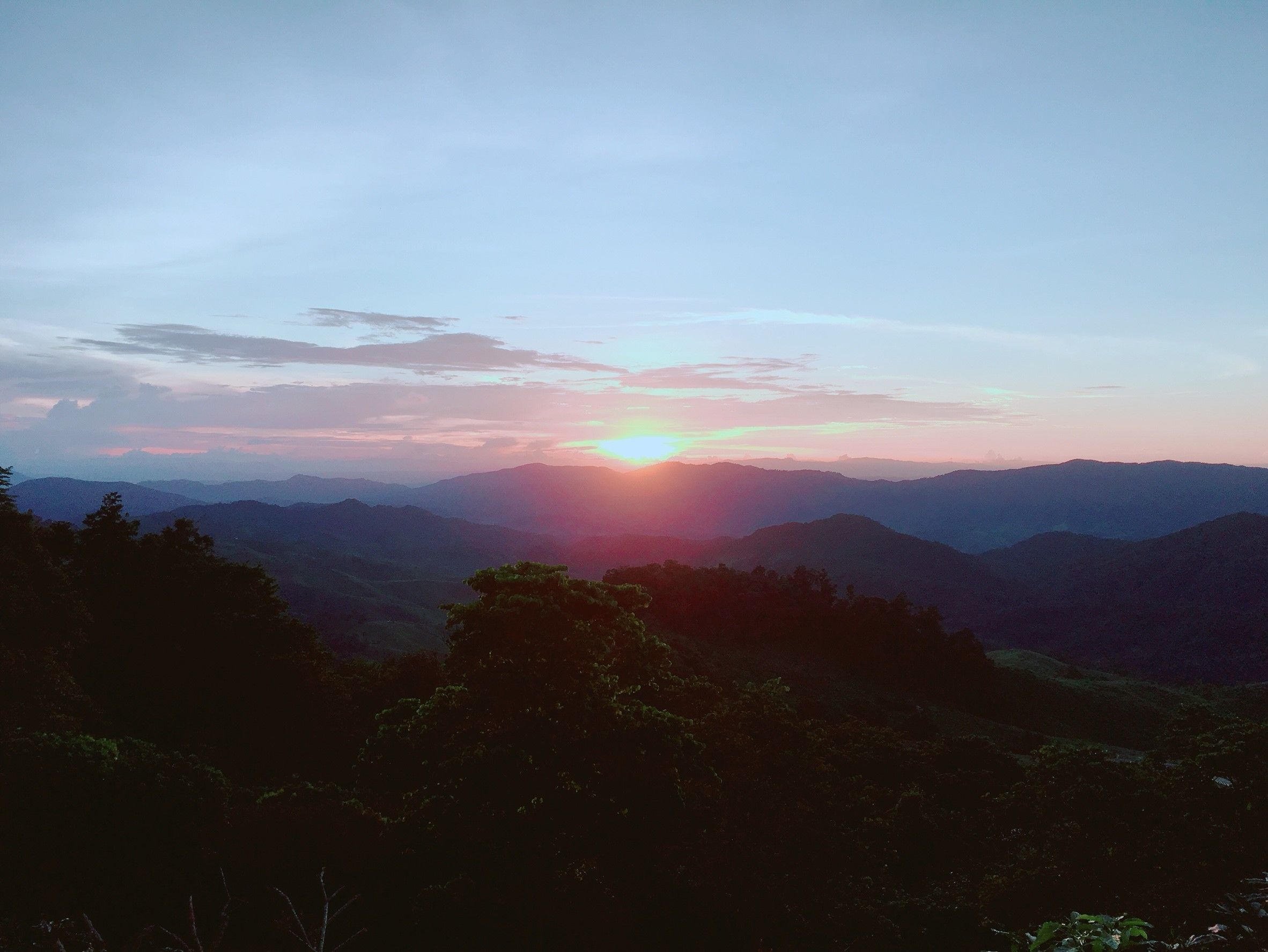 A mountainous landscape with a sunset.