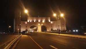 A large, illuminated archway at night, likely a historical or significant landmark. - Tanuf Residency Hotel (Nizwa)
