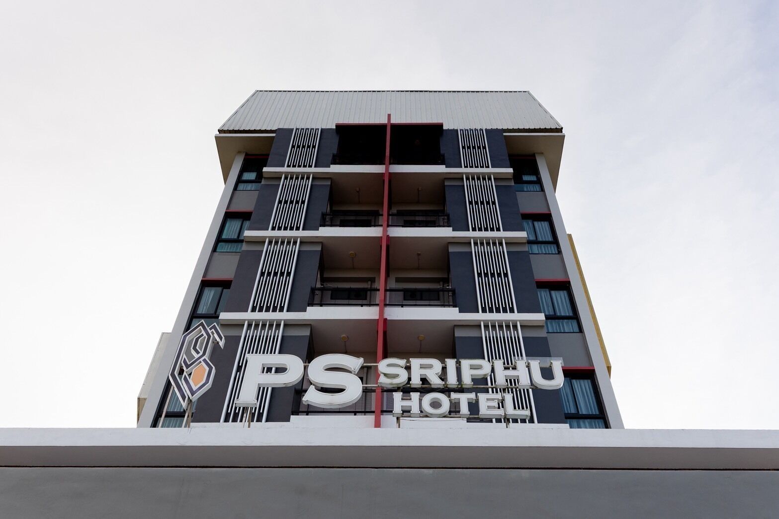 A multi-story building with a prominent sign for 'PS SRIPHU HOTEL' at the top.