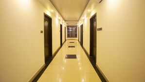 A long, well-lit hallway with doors on both sides and a shiny tiled floor. - The Cox Beach Resort (Cox's Bazar)