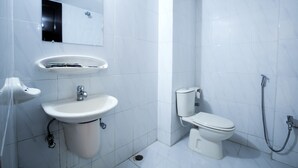 A modern bathroom with a pedestal sink, toilet, and shower. - The Cox Beach Resort (Cox's Bazar)