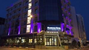 A Marigold Hotel with a modern design, featuring a prominent entrance and multiple balconies. - Marigold Hotel (Tunis)
