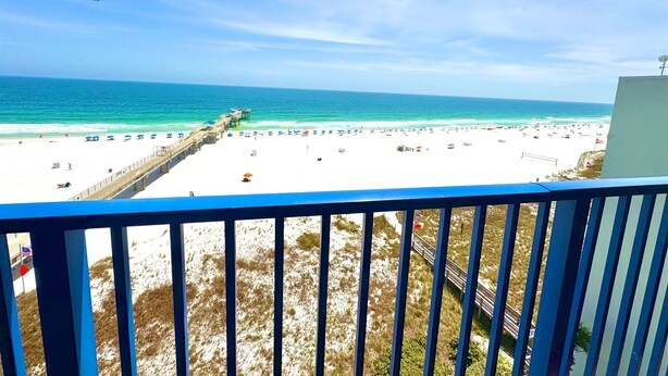 A beach view from a balcony with a railing, a pier, and a clear sky. - Pier!! Use a private fishing pier!  Direct Gulf View - Pool (Orange Beach)