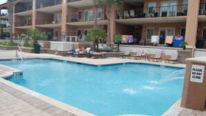 A swimming pool with lounge chairs and a 'Please do not climb' sign. - Brass Rail 3 Bed, 2.5 Bath Ocean View Top Floor Closest To Beach (Tybee Island)