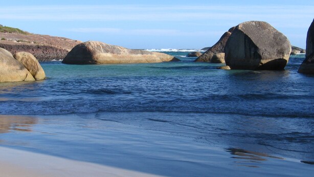 A beach with large boulders and calm water. - Braidwood Escape Denmark (Denmark)