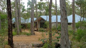 A forested area with several cabins featuring pitched roofs and wooden structures. - Braidwood Escape Denmark (Denmark)