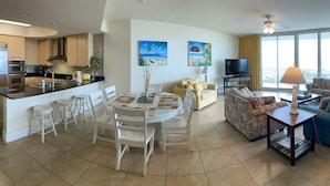 A modern apartment with a kitchen, dining area, living room, and balcony. - Resort Style Amenities. NO extra admin fees added. Amazing parking spot!  (Orange Beach)