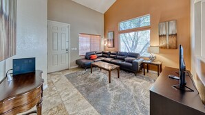 A spacious living room with a large sectional sofa, a coffee table, and a television on a stand. - Why stay in the confinement of a hotel,when you can stay in this Las Vegas oasis (Las Vegas)