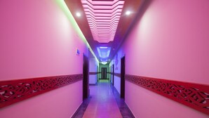 A hallway with a patterned ceiling and walls, leading to a door at the end. - Galaxy Resort Limited (Cox's Bazar)