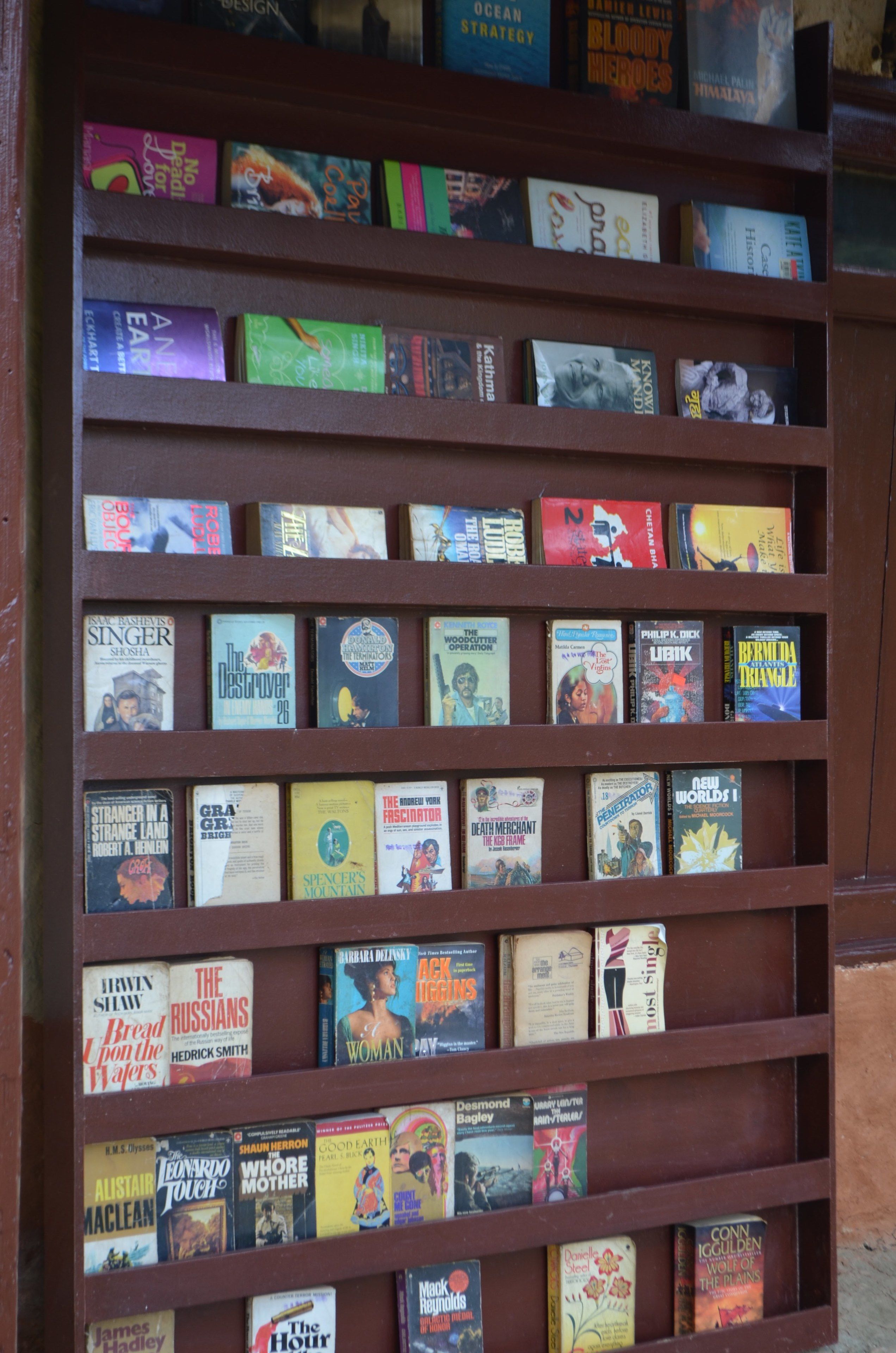 A bookshelf with various books.