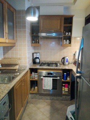 Apartment, 1 Bedroom | Private kitchen | Full-size fridge, microwave, oven, stovetop - Caro (Agadir)