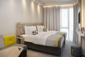 Ropa de cama hipoalergénica y caja de seguridad en la habitación