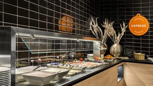 A buffet setup with various food items and a glass display case.