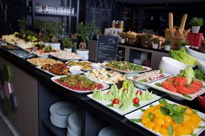 A buffet with various dishes and a sign indicating the location of Burada. - ibis Styles Istanbul Bomonti (Istanbul)
