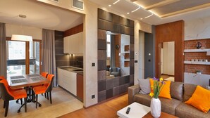 A modern living room with a sofa, coffee table, and dining area. - Passpartù (Belgrade)