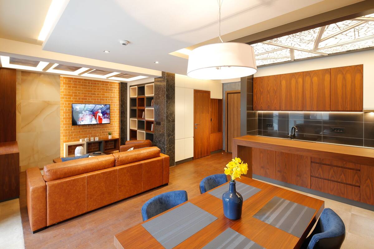 A modern kitchen with wooden cabinets and a built-in oven.