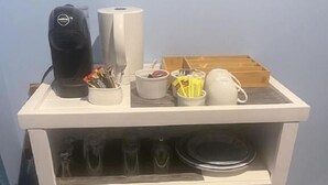 A kitchenette with a coffee maker, a kettle, a small refrigerator, and a microwave. - Tambaridge Bed and Breakfast (Wongawallan)