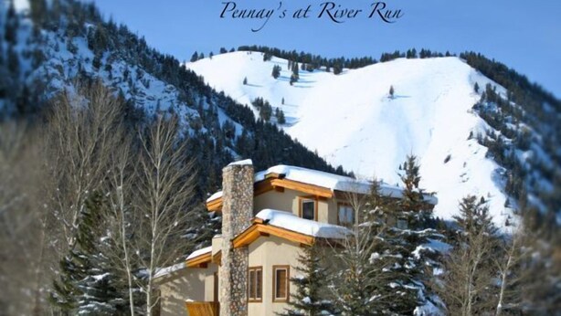 A snow-covered mountain with a cabin featuring stone and wooden architecture, surrounded by trees. - NEW 1 bedroom condo. This is the best location in Ketchum! (Ketchum)