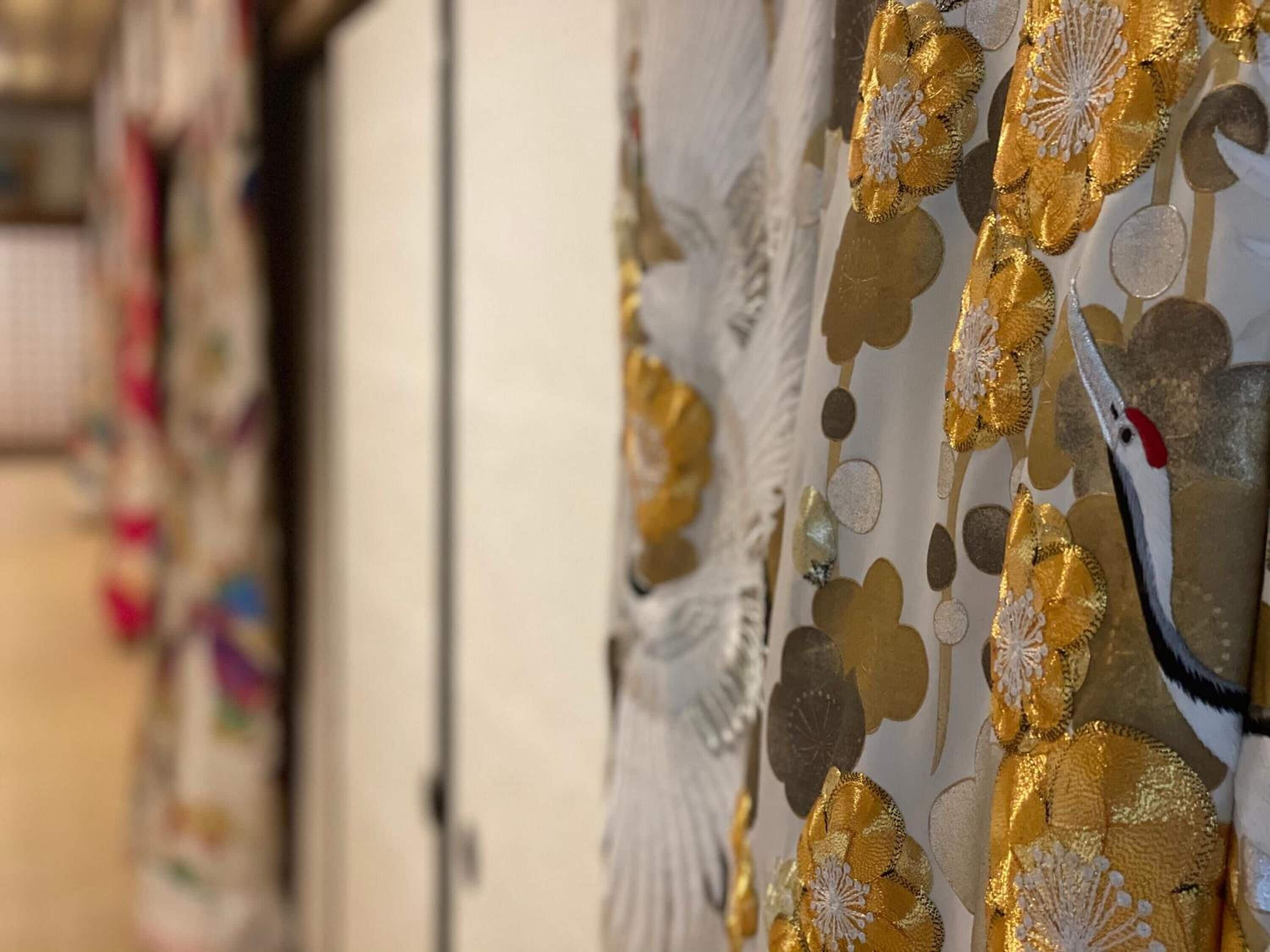 A close-up of a curtain with a gold and white pattern.