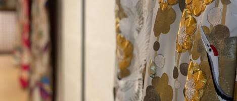 A close-up of a curtain with a gold and white pattern.