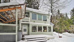 A two-story house with a covered porch and a snow-covered roof. - Cabin w/ Hot Tub & Views: 1 Mile to Alyeska Resort (Girdwood)