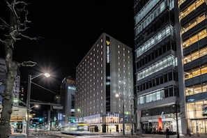 A modern hotel building with multiple floors, large windows, and a prominent sign for HOTEL VISTA. - Hotel Vista Hiroshima (Hiroshima)