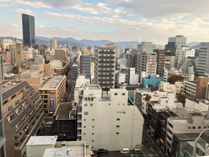 A cityscape with various buildings, including a prominent skyscraper and several mid-rise structures.