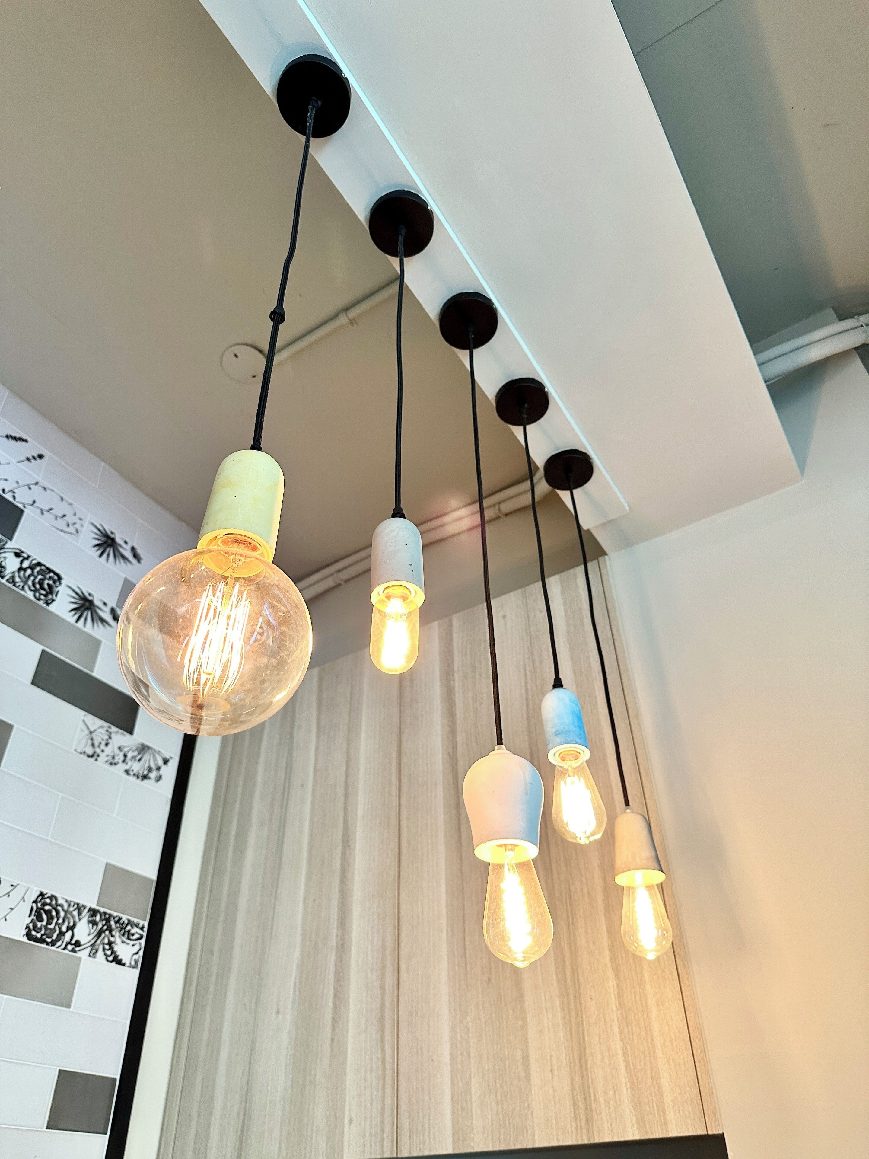 A ceiling with multiple hanging pendant lights.