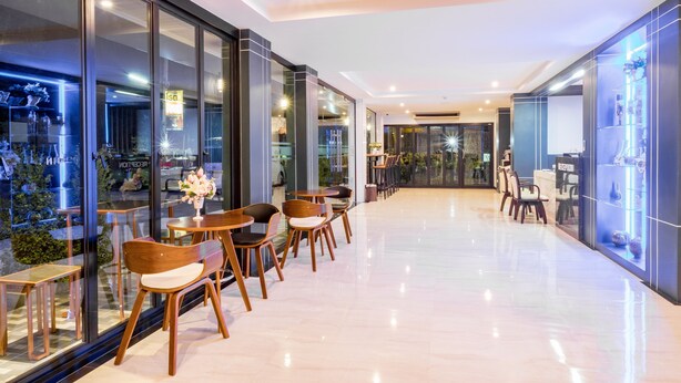 A modern interior with glass walls, wooden chairs, and a clean, polished floor. - Sita Krabi Hotel (Krabi)