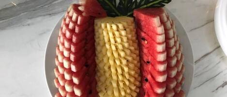 A plate with a watermelon and corn arrangement.