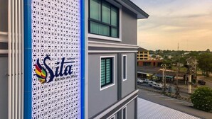 A modern hotel with a distinctive perforated facade and a view of the surrounding cityscape. - Sita Krabi Hotel (Krabi)