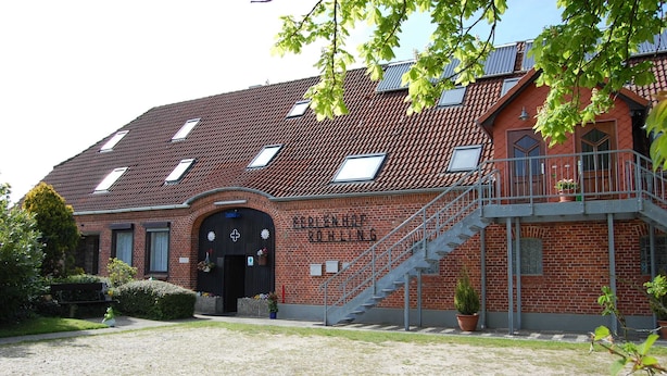 A building with a red-tiled roof, a staircase leading to an upper level, and a sign that reads "STUDENT HOUSING". - Vacation apartment Stör - Ferienhof Röhling between Schlei and Baltic Sea (Kappeln)