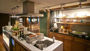 A modern kitchen with a built-in sink, a coffee station, and a variety of food items. - Walkerhill Douglas House (Seoul)