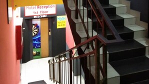 A staircase leading to the 1st floor hotel reception.