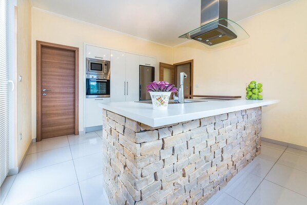 Fridge, stovetop, dishwasher, coffee/tea maker