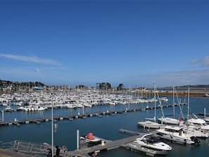 A marina with numerous boats docked at piers. - Charming 3* House, Enclosed Garden, Terrace, Near Perros-Guirec Marina, Free WIFI (Perros-Guirec)