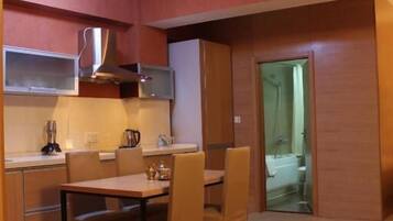 A compact kitchen with a dining area, a microwave, and a stove.