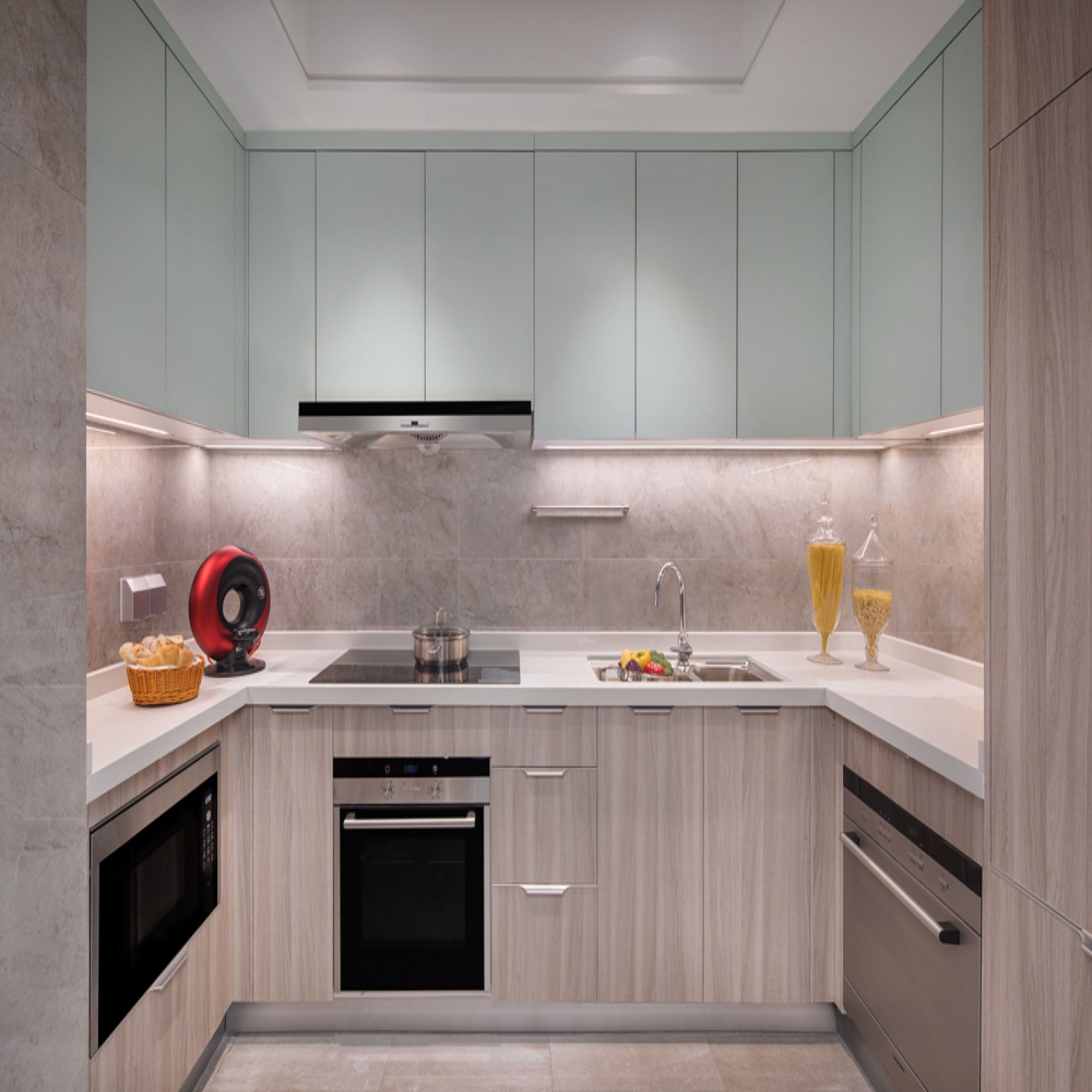 A compact kitchen with a built-in oven, a microwave, a sink, and a dishwasher.