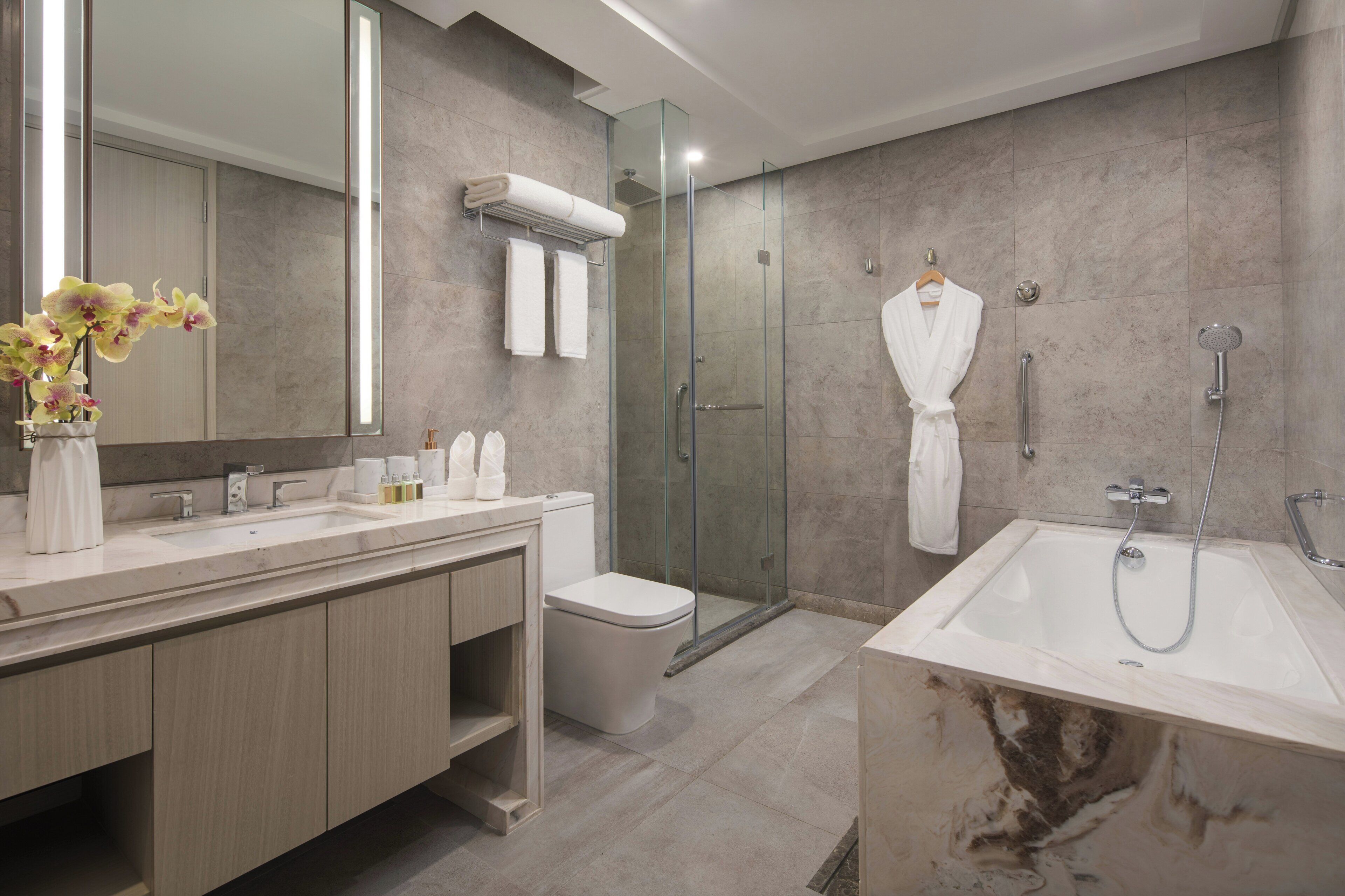 Ein modernes Badezimmer mit einer Duschkabine, einer Badewanne und einem WC.