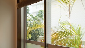 A window with a view of a balcony and plants. - La Passione Boutique B&B (Naha)