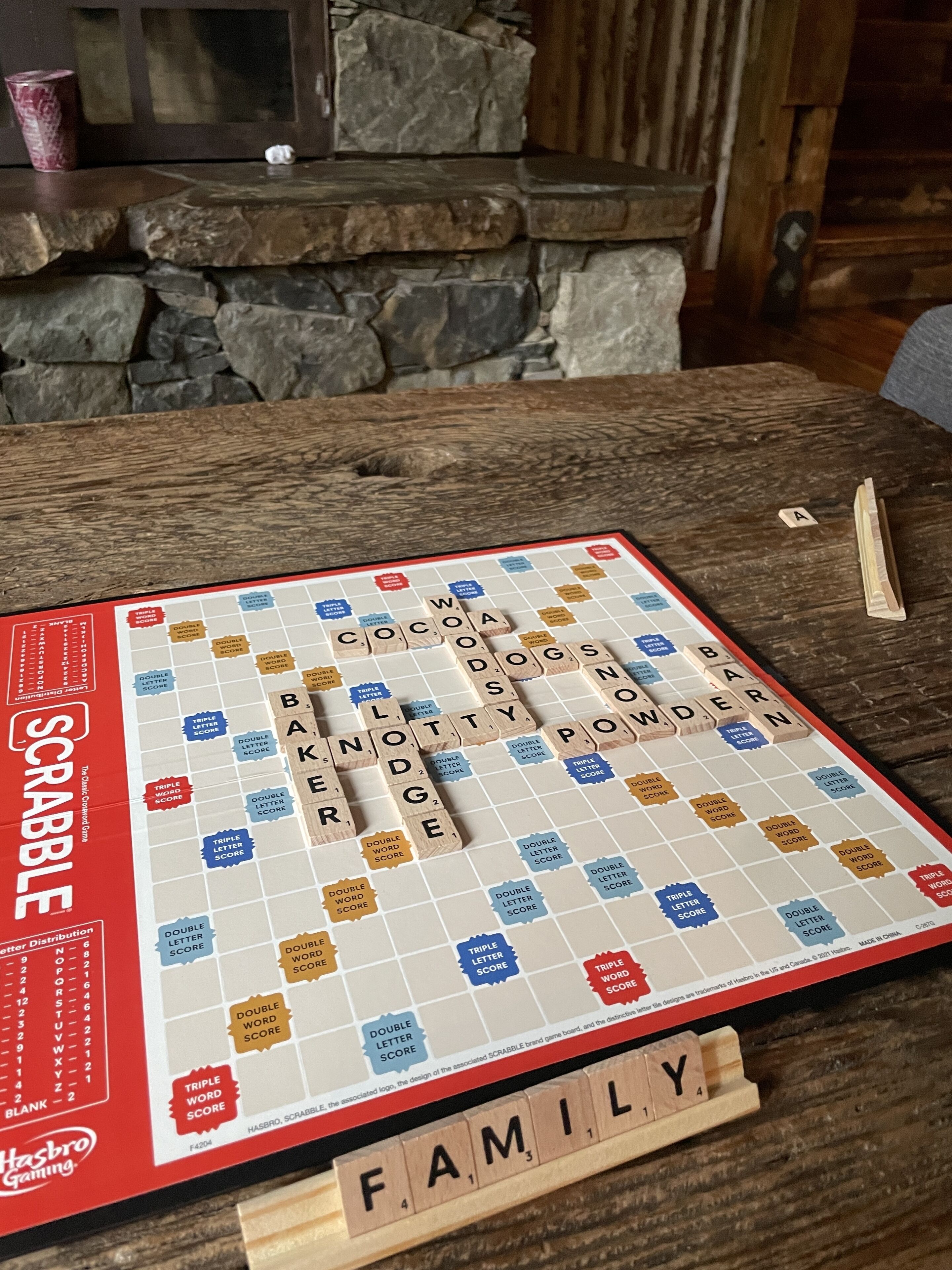 A Scrabble game board with the word 'FAMILY' spelled out at the bottom.