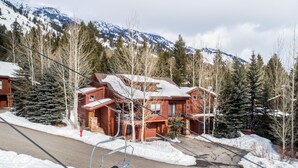 A lodge with a ski lift, surrounded by snow-covered trees and mountains. - Outpost: Moose Creek 20 - Private Hot Tub! (Teton Village)