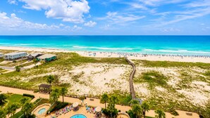 A beach resort with a pool area, beach chairs, and a boardwalk. - Corner Unit A1110 Kng/Qn/Bunk/Sofa Sleeper Direct Gulf View-WIFI - Sleeps 9 (Gulf Shores)