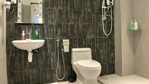A modern bathroom with a white sink, toilet, and shower. - iBook6 Deluxe Family Suite for 4 by iBook Homestay (George Town)