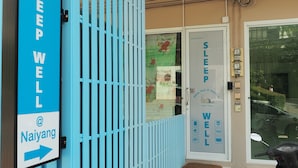A blue gate with a sign for Sleep Well @ Naiyang. - Sleepwell@Naiyang (Sa Khu)